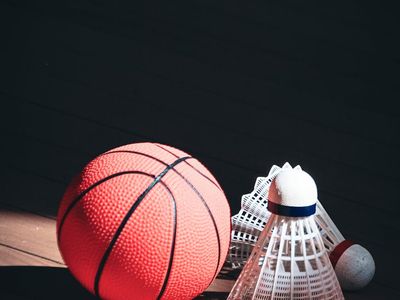 Close-up of athletic gear neatly arranged on a dark floor.