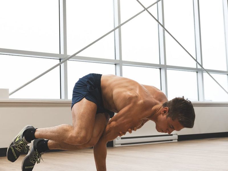 Man holding a difficult balance pose, showing core strength.